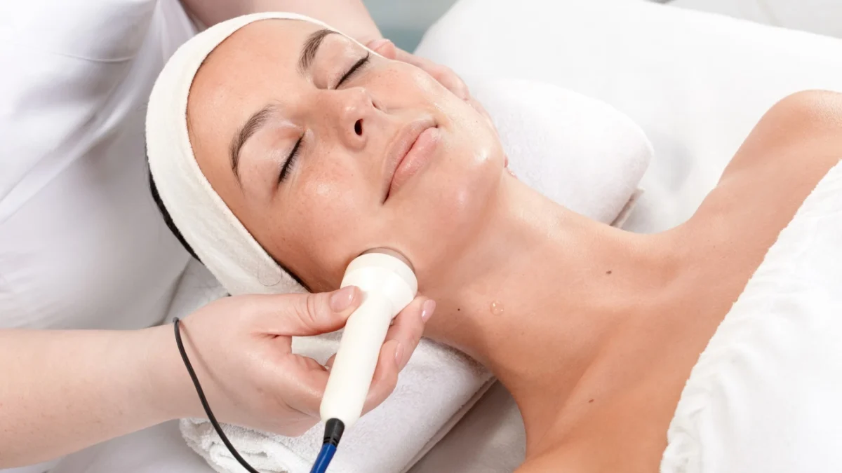 A woman receiving a facial with an ultrasonic cleanser.